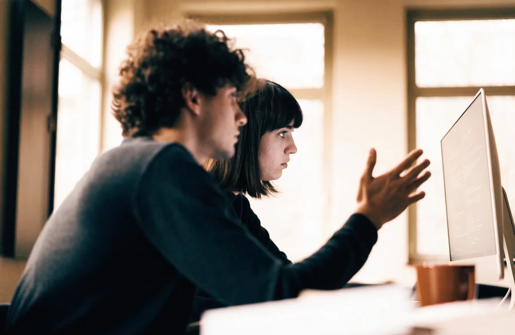 Two developers sharing one screen while working through code together